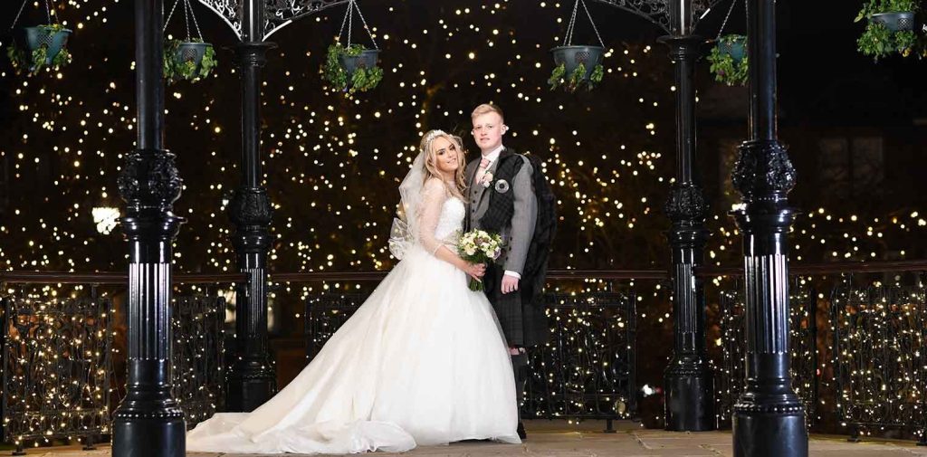 Lanarkshire wedding photographer: Bride with a long veil and white rose bouquet
